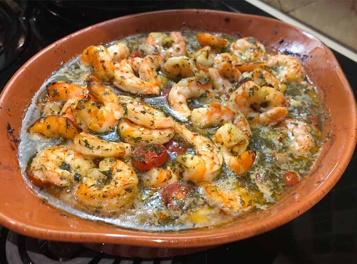 Spicy shrimp pasta finished with herbs and Parmesan cheese.